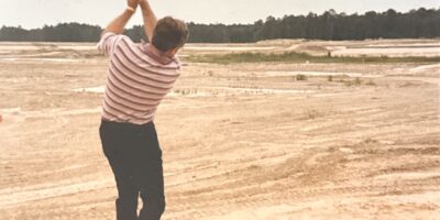 Earl Higgins hits a shot on the first golf course in The Woodlands before its grass has even grown in. (Courtesy Earl Higgins)